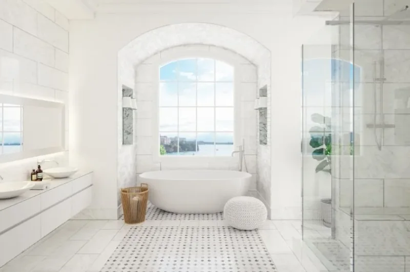 Light bathroom with a freestanding bath and glass shower